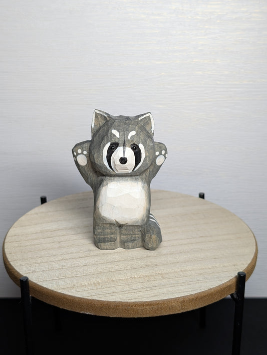 Hand painted wooden raccoon carvings